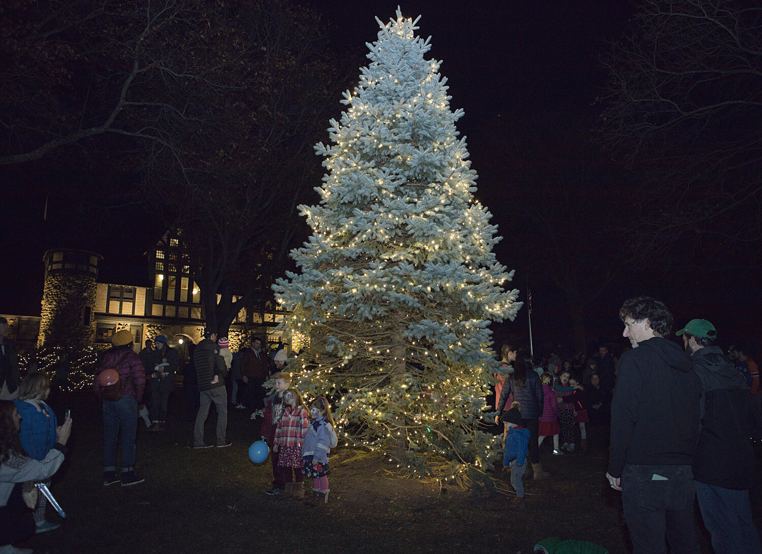 The crowd gathers around the large evergreen during Saturday’s tree-lighting event in Barrington.