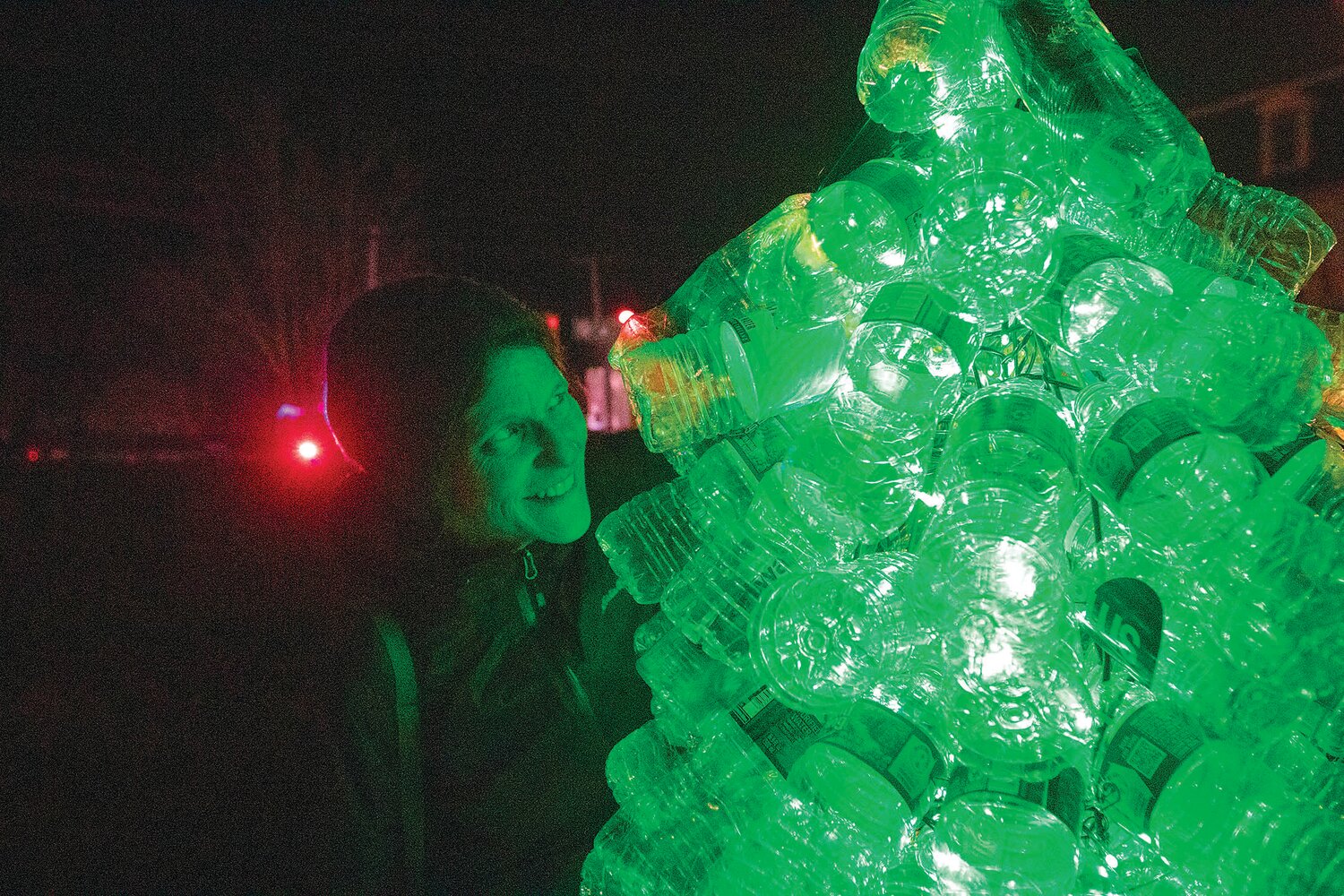 Jenny Wieting puts the finishing touches on a tree made of platic water bottles. She is trying to get exposure to help the state pass a bottle bill.