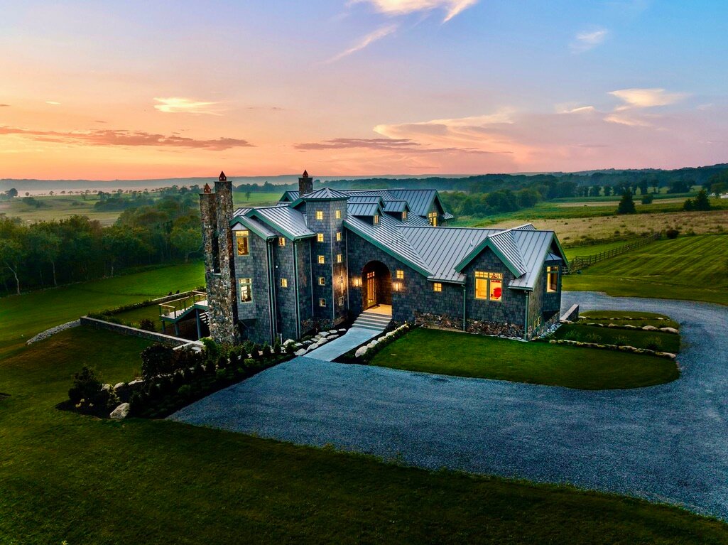 Built into a hillside overlooking the Seapowet marshes in South Tiverton, this new home is on the market for $4,995,000. Surrounding it are a few scattered houses and pastoral fields, as well as a path through the trees leading down to the water.
