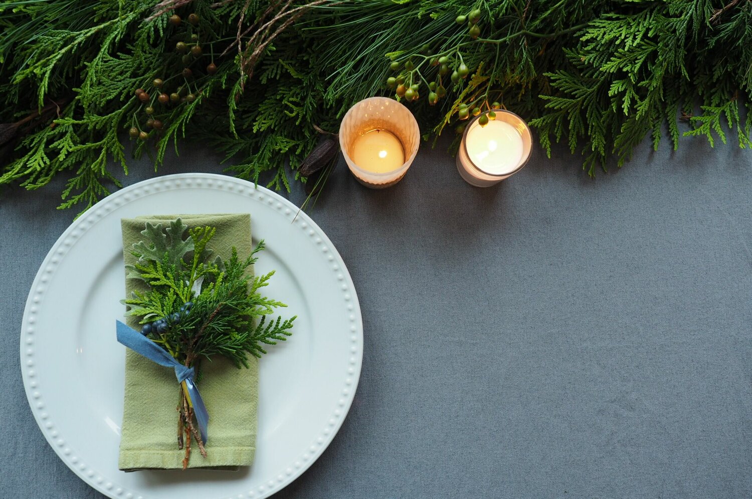 A few simple clippings from the yard or nearby woods can be transformed into striking decorations for a holiday table.