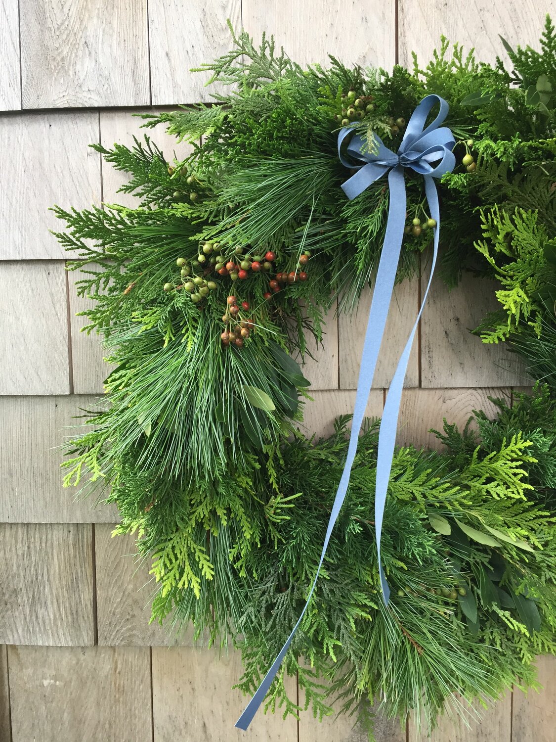 With a wire frame, a few green clippings and some ribbon, anyone can create their own custom wreath.