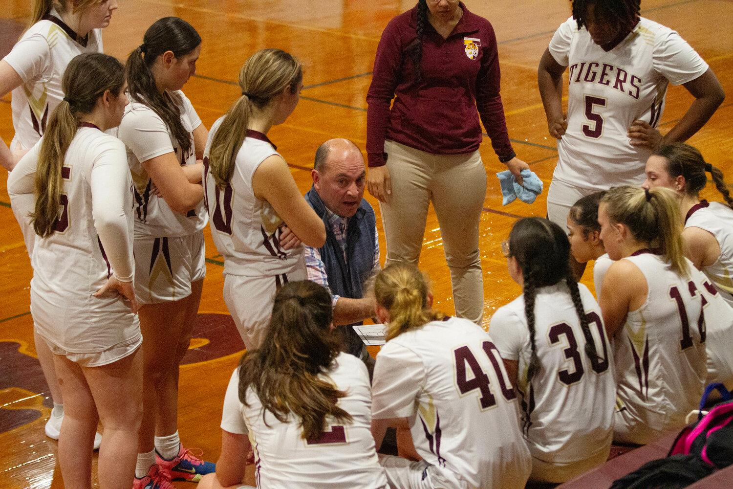 Coach Michael Brigham speaks to the team between quarters during their loss to Moses Brown on Thursday night. 