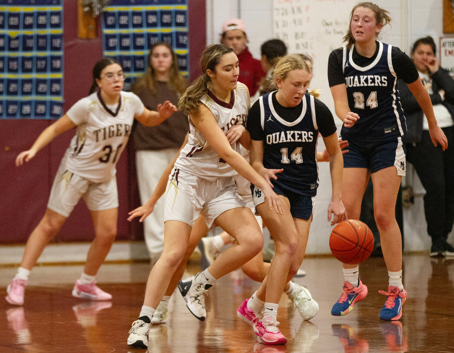 Cami Oliveira (left) looks on while teammate Laney LePage (middle) makes a steal during the game. 