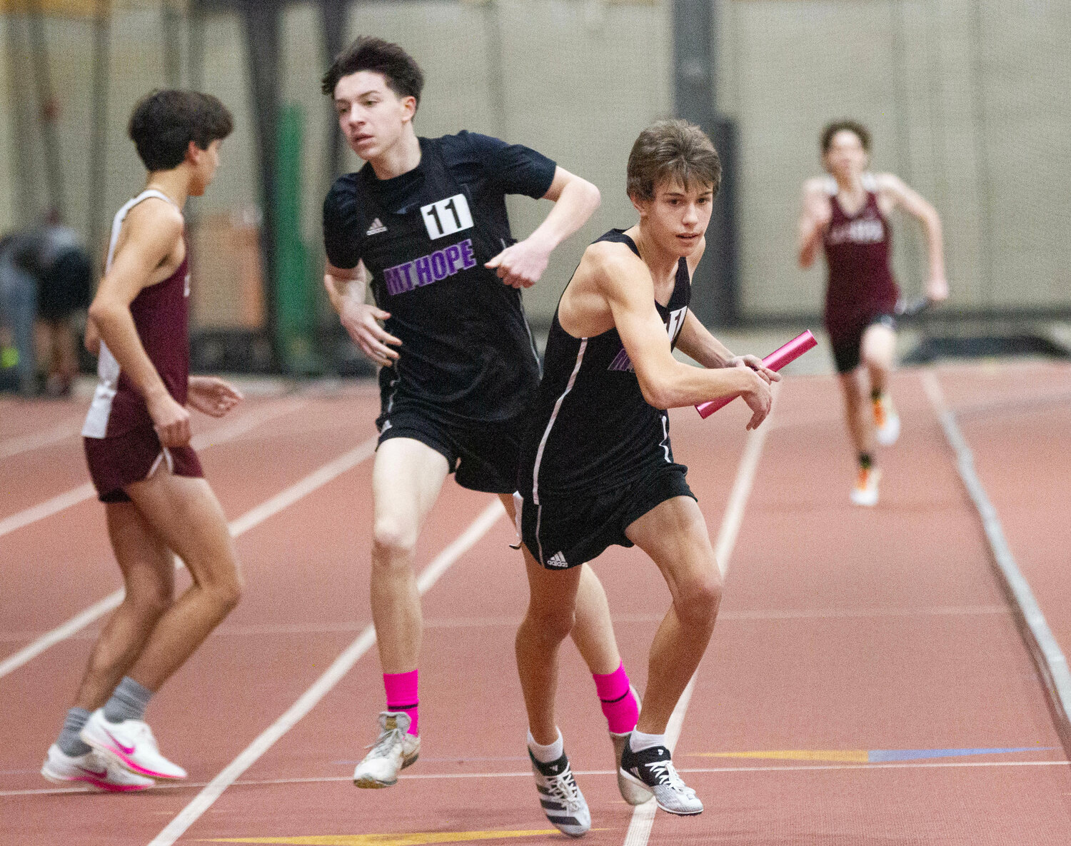 Andy Charest hands the baton to Jackson Lopes during the 4x800 meter run.