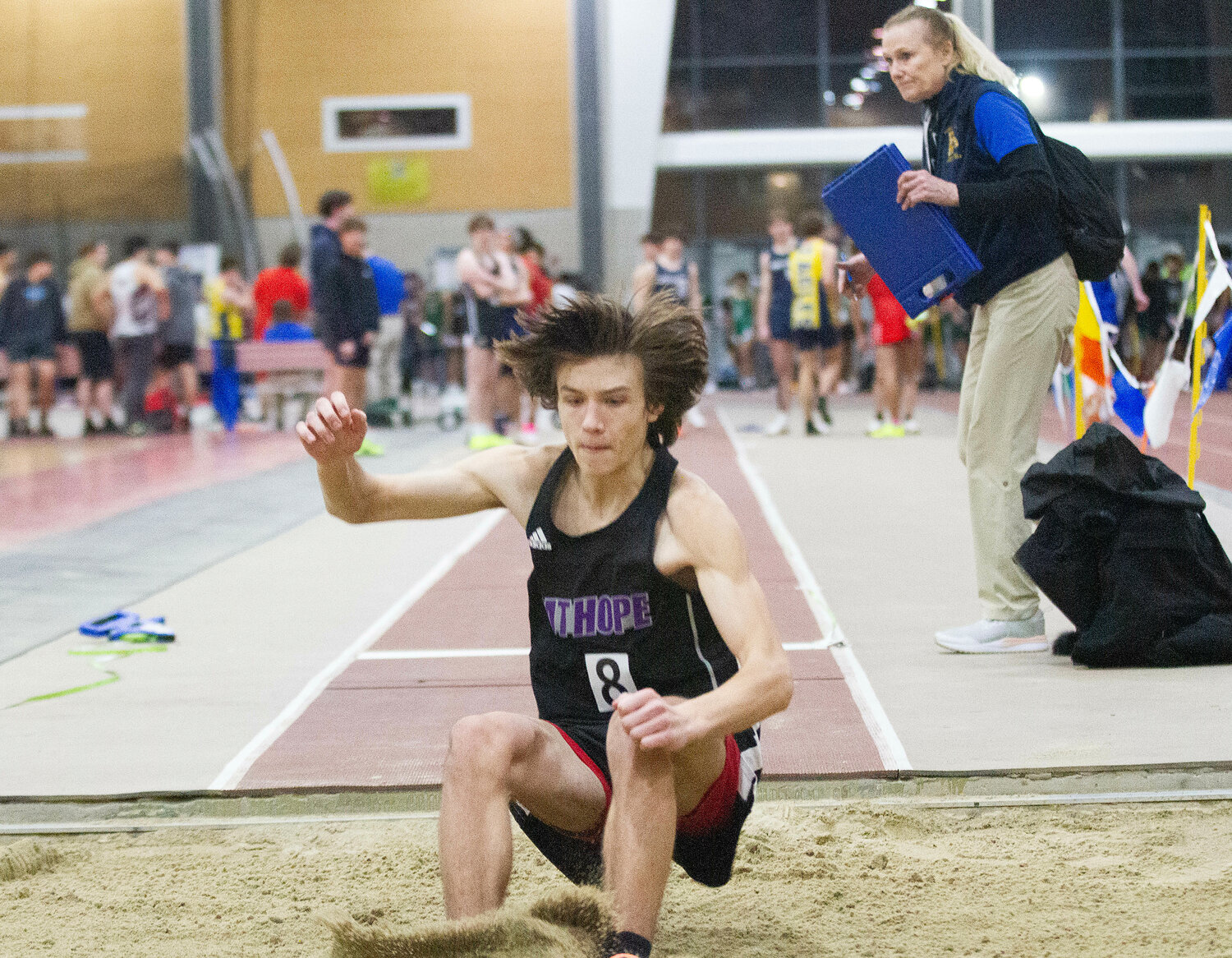 Jack Cicchinelli leaps into the sand during the long jump.