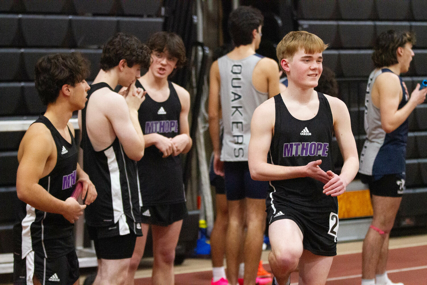 Logan Toste (left) Tyler Scarborough (right) and their teammates prepare for the 4x200 meter relay race.