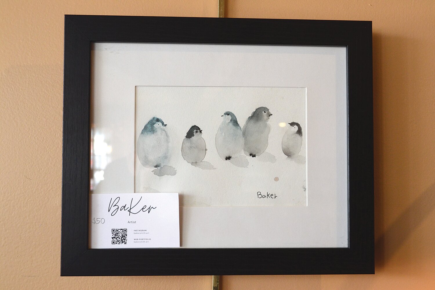 A watercolor painting of penguins Baker has on display, which showcases impressive detail and brushwork.