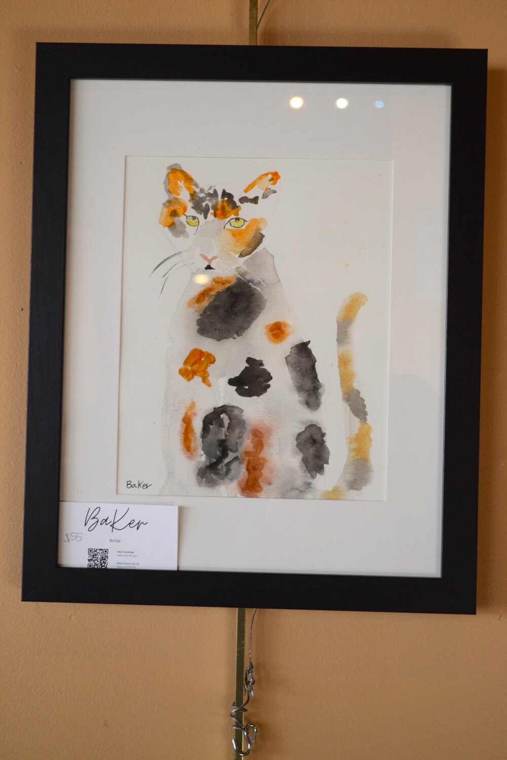 A calico cat shows Baker’s use of colors and negative space.