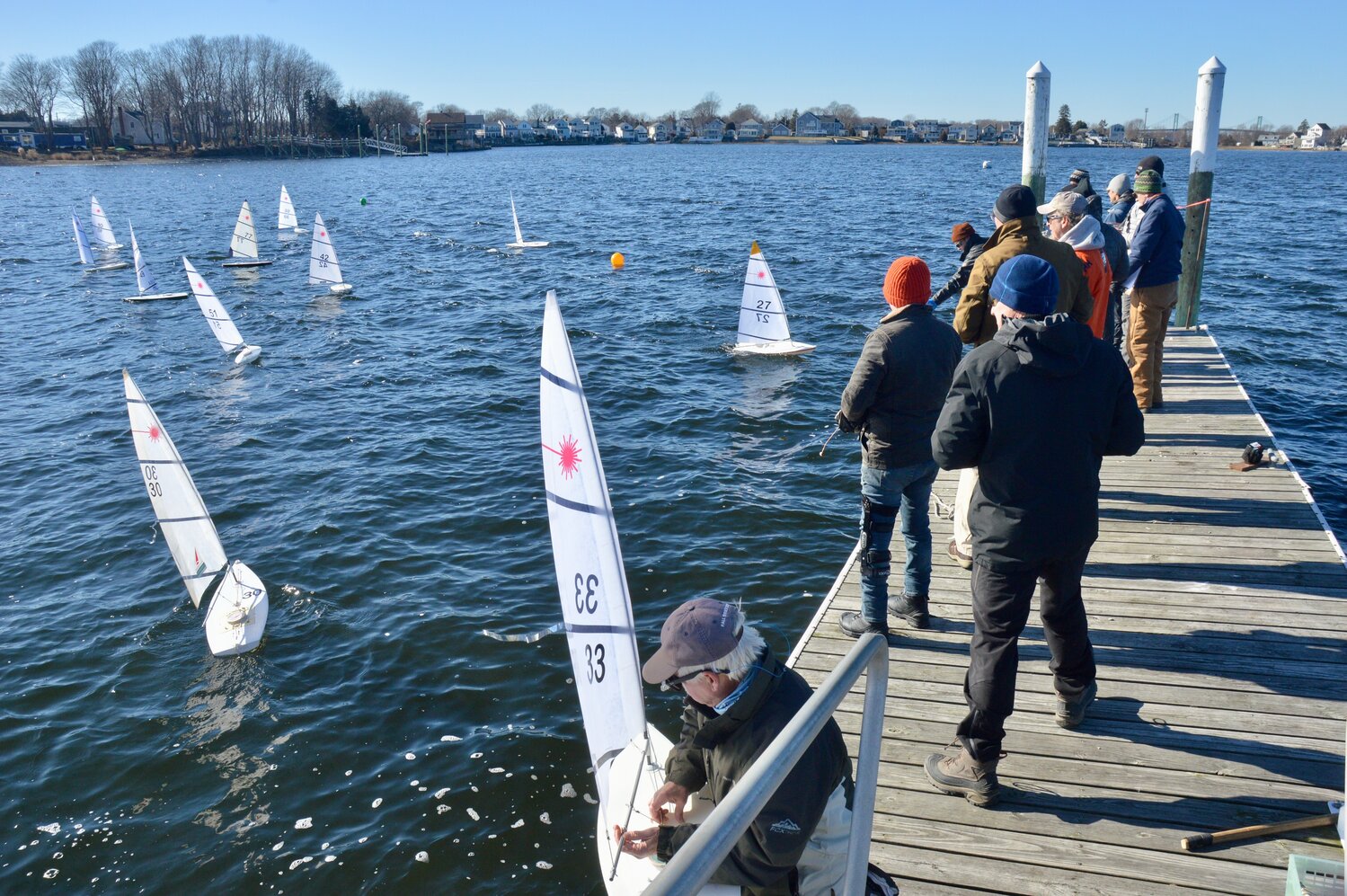 A crowded field of racers jockey for position as they wait for the start of one race in Blue Bill Cove in Portsmouth on Sunday.