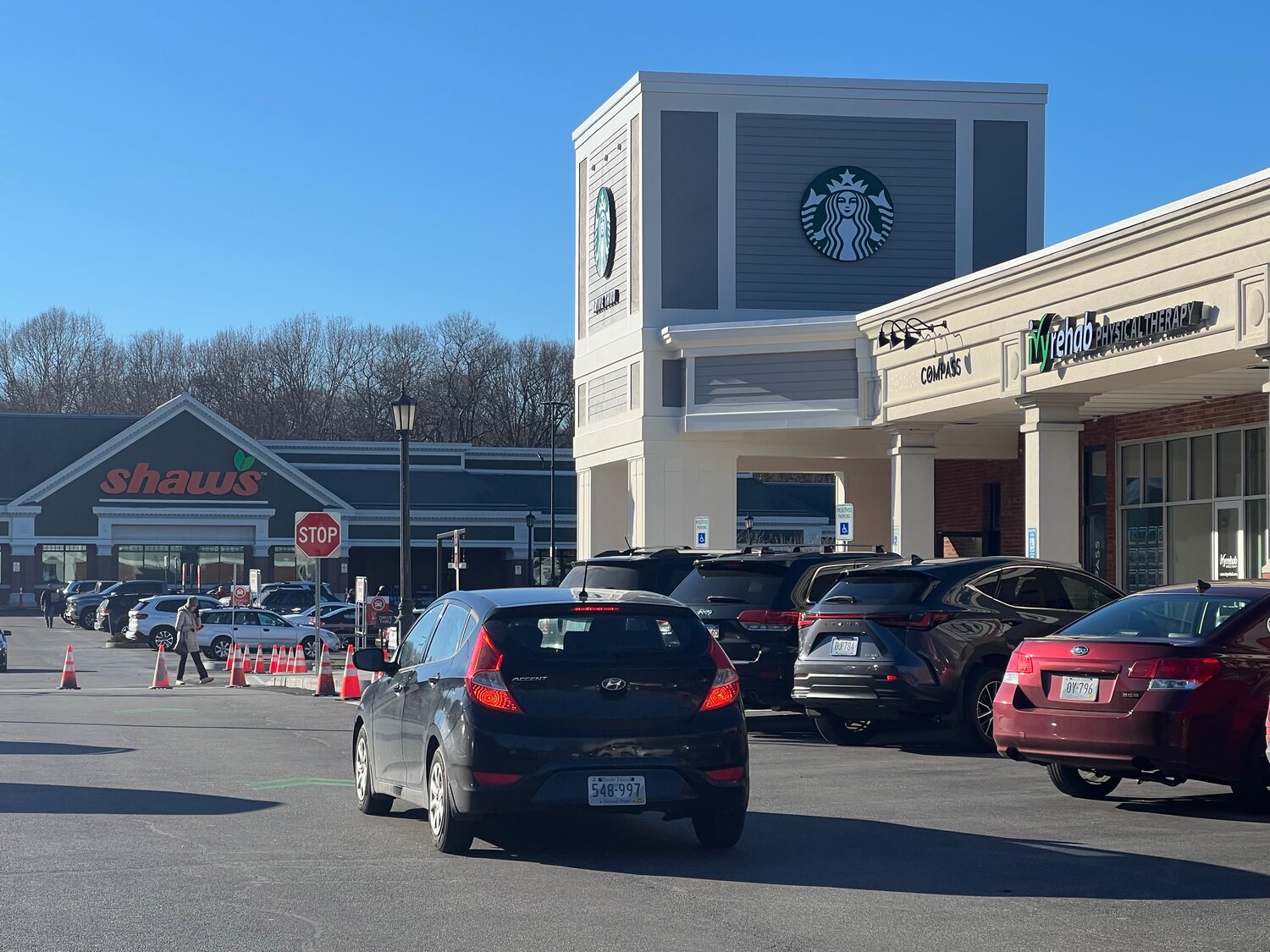 A vehicle drives through the Barrington Shopping Center, past the new Starbucks coffee shop which is expected to open soon. The store features the town’s first-ever drive-through lane for a restaurant.