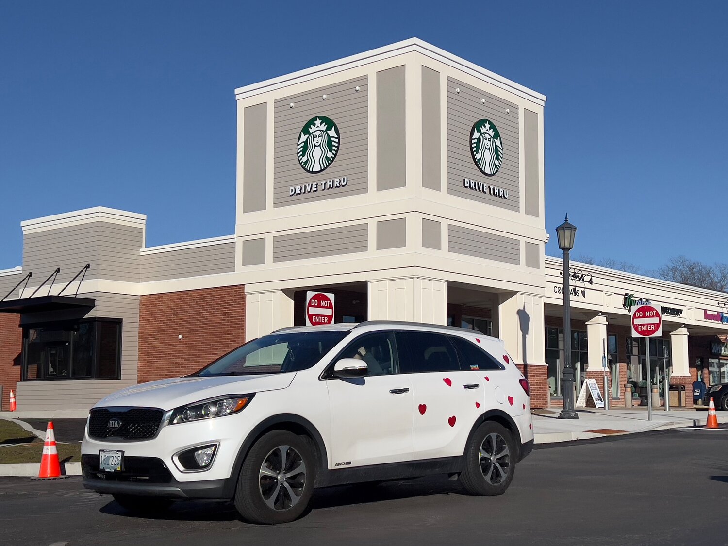 A vehicle drives through the Barrington Shopping Center, past the new Starbucks coffee shop which is expected to open soon. The store features the town’s first-ever drive-through lane for a restaurant.