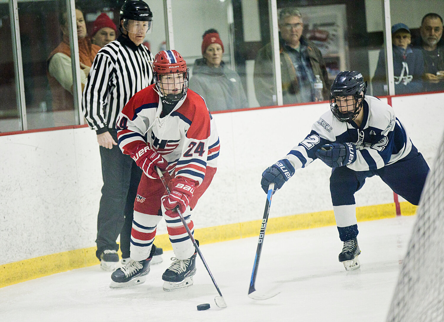 Luke Brule skates around the back of the net while controlling the puck for Portsmouth.