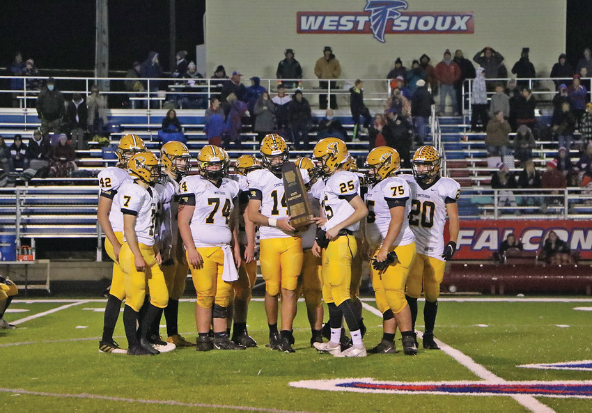 A CLASS ACT --  The E-Hawks would fall to West Sioux 35-16 in Friday night&rsquo;s Class 1A third round playoff contest. Pictured above, after a great 7-2 season, Emmetsburg accepts the IHSAA participant trophy following Friday&rsquo;s game.