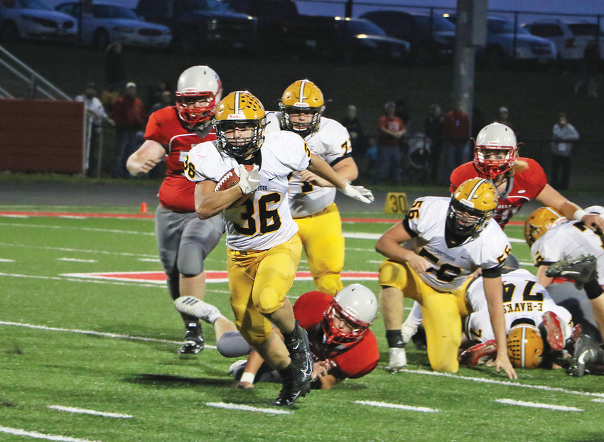 EXTRA EFFORT -- Colby Weir drags a Rebel defender along for the ride during a first down pick up last Friday night. Weir would score two touchdowns on the night and rush for 106 yards against Sioux Central. -- Joseph Schany photo