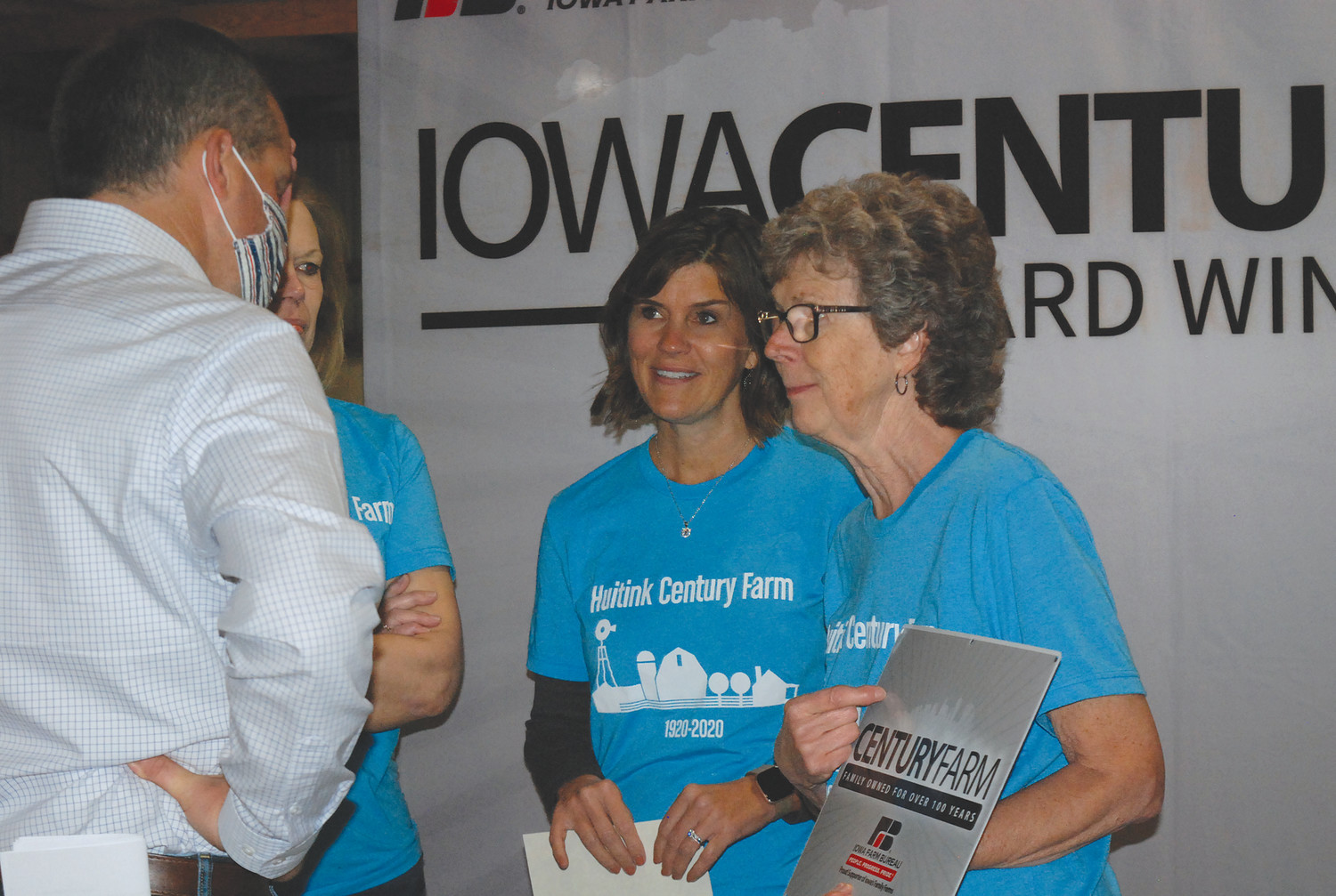 CENTURY FARM -- Iowa Secretary of Agriculture Mike Naig is pictured visiting with members of the Huitink family from Sioux County. Naig and Iowa Farm Bureau Federation President Craig Hill presented Century Farm Awards to two Northwest Iowa families last week at the Palo Alto County Fairgrounds in Emmetsburg.            --Jane Whitmore photo