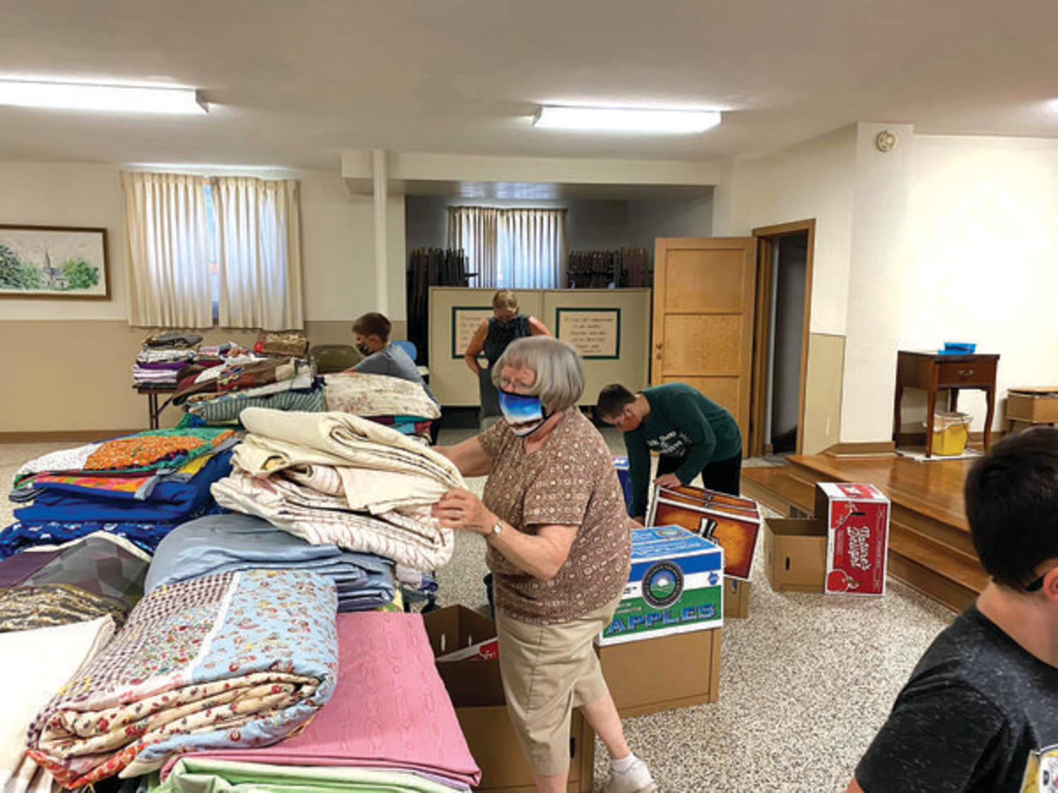 LUTHERAN WORLD RELIEF -- The quilting groups made 311 quilts in the past year. Elaine Nauss (in front), Drake Mehan, Kathy Mehan and Miriam Morlock are pictured getting the quilts and 81 kits ready to send to Lutheran World Relief.                     --submitted photos
