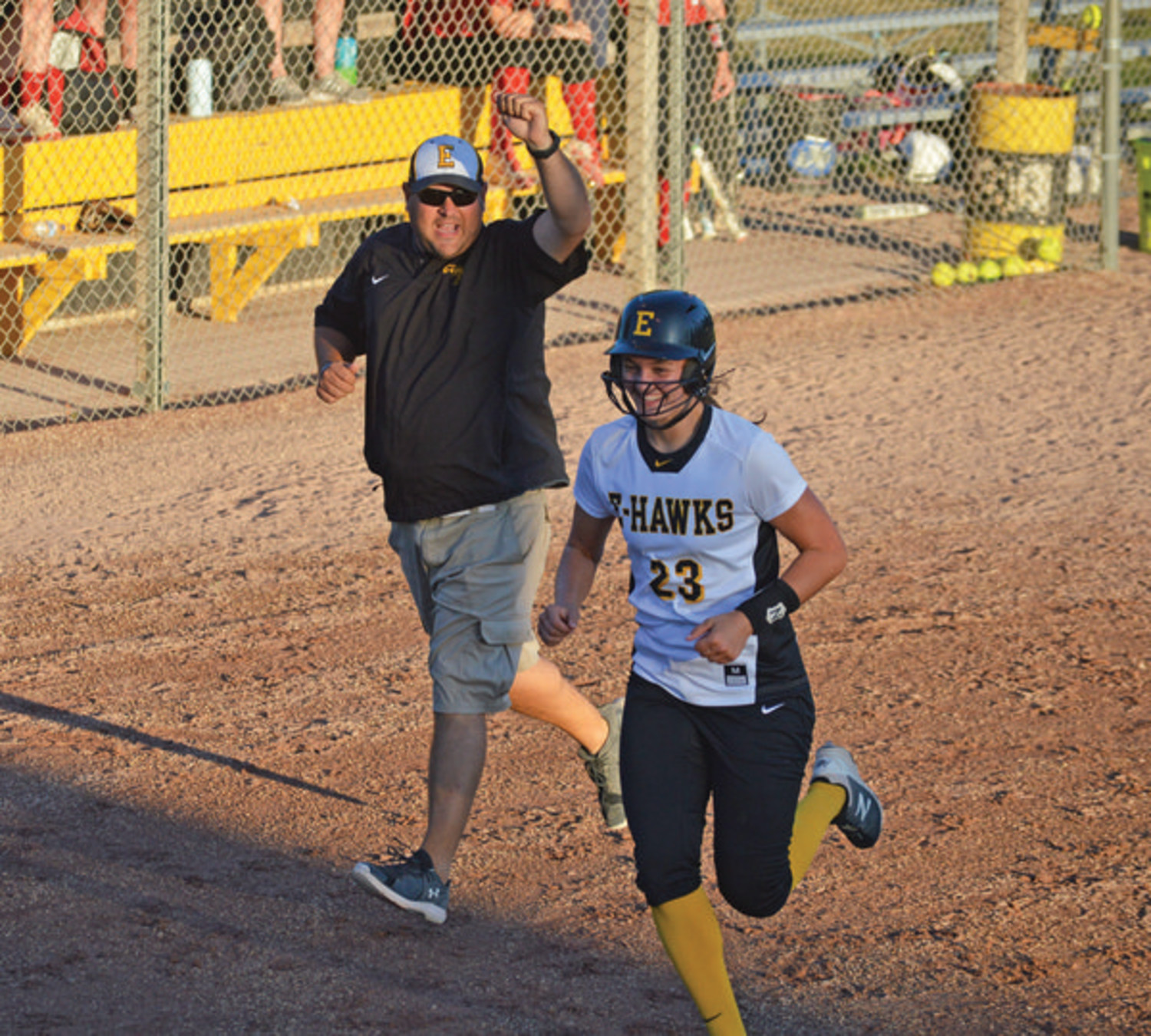 IT’S GONE! - Pictured above, Molly Schany smashes a long home run during Wednesday night’s 11-1 Lady E-Hawk win over East Sac County to close out the contest in the fifth inning. Rounding the bases, Schany was joined in celebration by head coach Travis Birkey. Schany went 2-for-2 at the plate during the game. --Joseph Schany photo