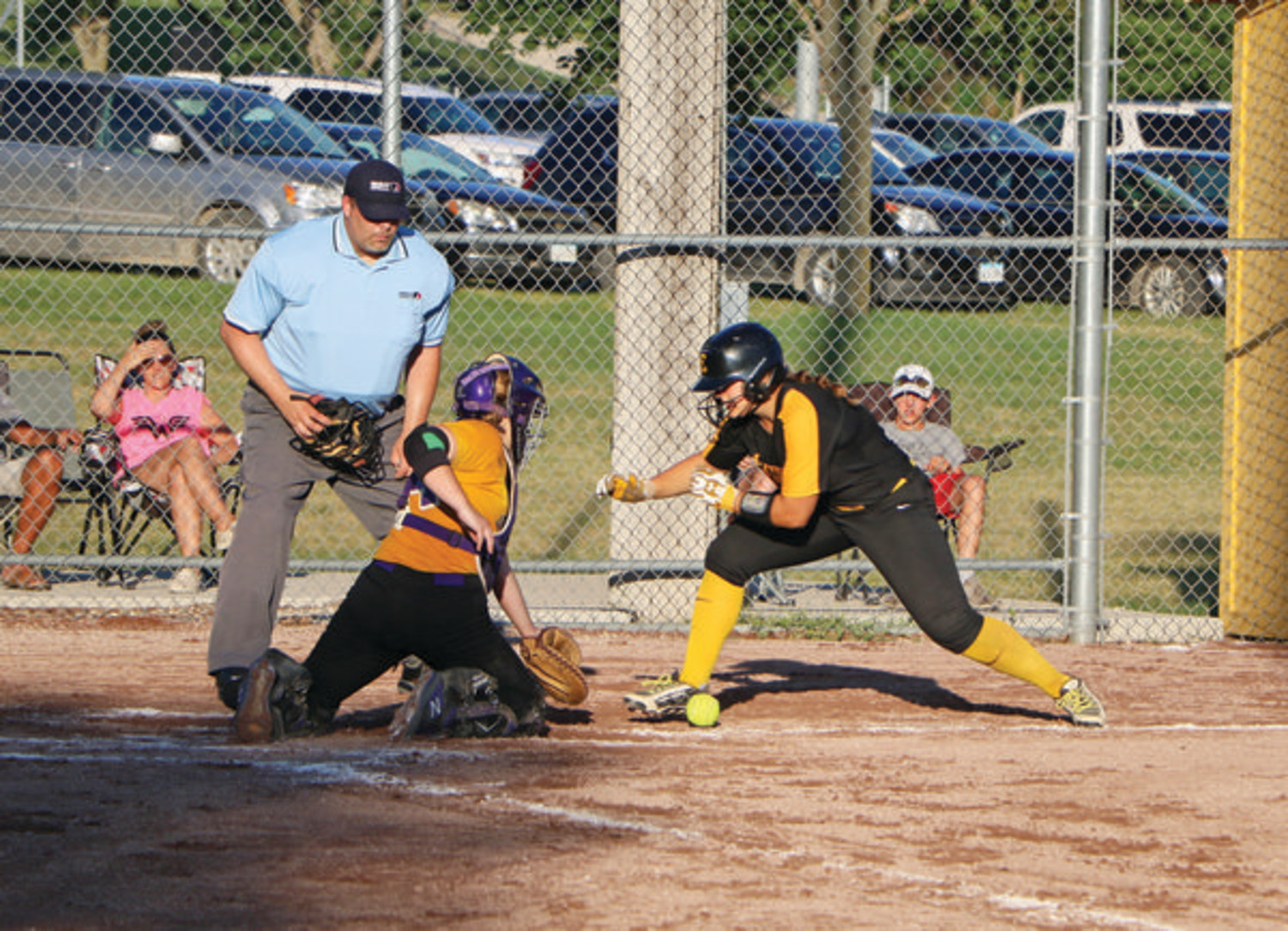 SAFE AT HOME - On Thursday, Emmetsburg’s Cheyanne Fries (right) prepares for a battle at home plate against West Bend-Mallard’s Anna Ackerman, but scores before the ball arrives. The Lady E-Hawks would get the win, 11-1.                        -- Joseph Schany photo