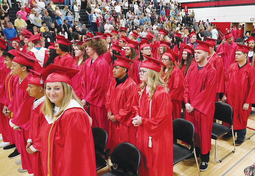 ELC graduates stand while they wait for the rest of their classmates to enter the gym during the processional of Sunday’s commencement.