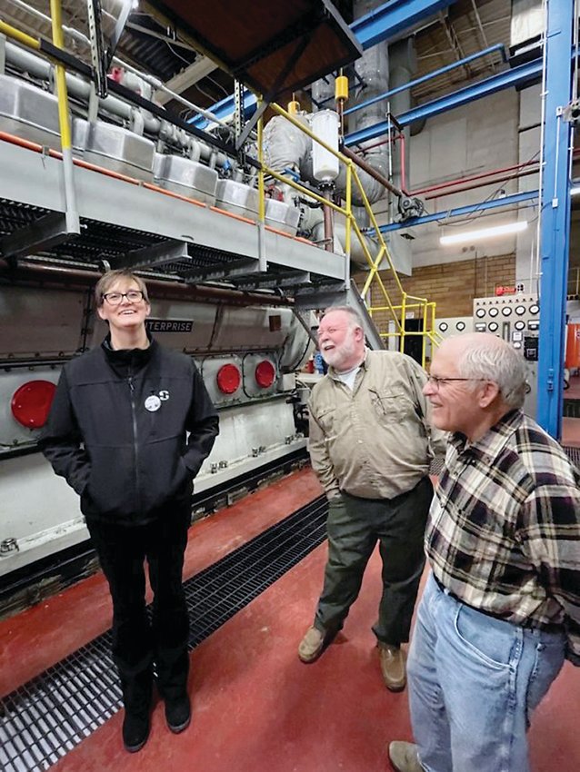 Bret Mace, electric foreman, shares a laugh with council members Joan Heckard, left, and Dave Seylar, right, between two of the electric generation units.   Photos by Amy H. Peterson