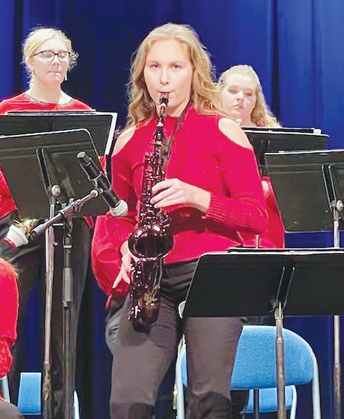 Grace Lutat performed a solo on her red alto sax during each of the three competition songs.   Photo by Amy H. Peterson