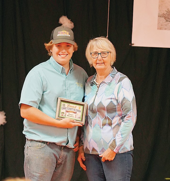 Emmet County Fair Board member Kadin Walter, left, presents the 2022 Friend of the Fair award to Georgia Whitehouse.   Photo by Amy H. Peterson
