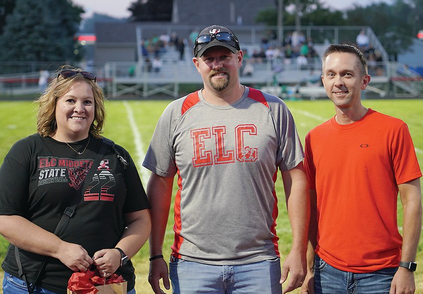 Dean Gesch, center, presented   Marcy and Kevin Sander with the ELC Booster Club Fans of the Year Award at halftime of Friday&rsquo;s football game with Storm Lake.  Photo by David Swartz