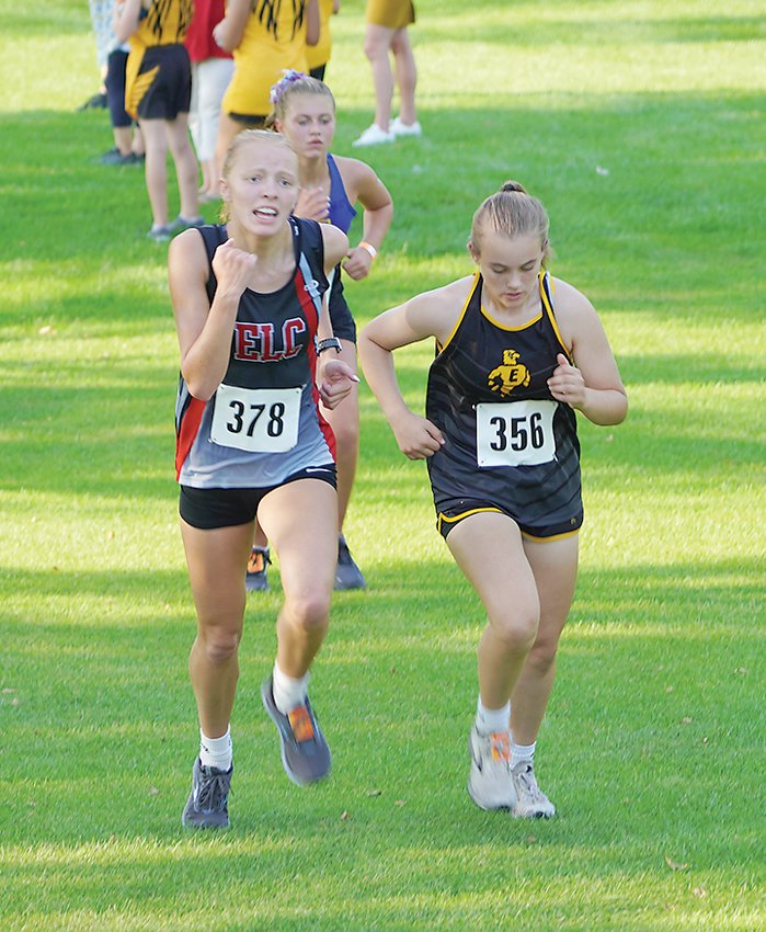 ELC&rsquo;s cross country course at the Estherville Golf Course is known for its many hills. Above, ELC&rsquo;s Brei Christoffer charges up a hill to pass an Emmetsburg runner.  Photo by David Swartz