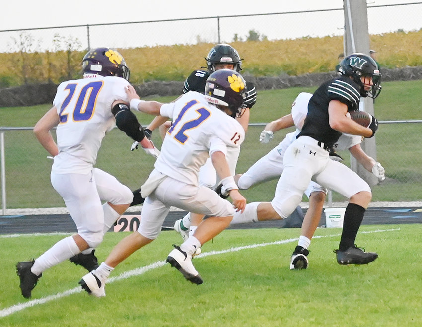 North Union&rsquo;s Bryer Prochniak breaks away from the Lake Mills defense towards the goal line to score the first touchdown during the Warriors&rsquo; homecoming game last Friday.  Photo by Kim Meyer, Bancroft Register