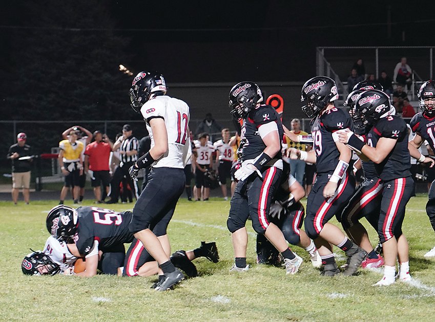 ELC&rsquo;s Jordan Jensen (56) was the first defender to reach the quarterback on this play against Clarion-Goldfield-Dows as the Midgets won their homecoming 27-13 over the Cowboys. ELC&rsquo;s defense held the visitors&rsquo; offense to 64 total yards in the second half.  Photo by David Swartz