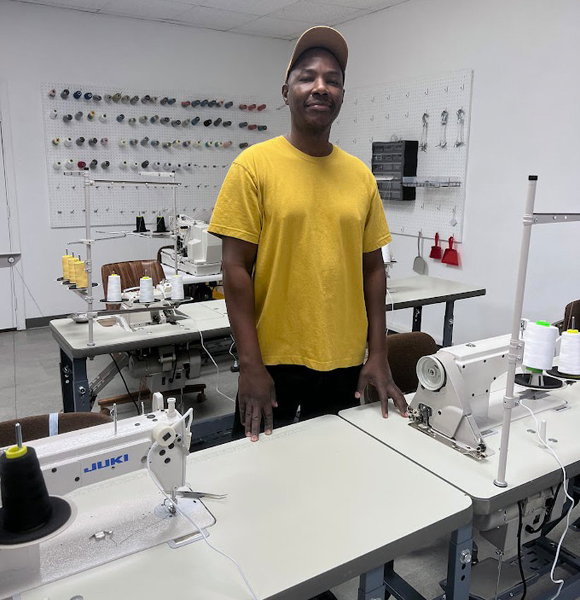 Chacha Kora has purchased the building and business of what is now Estherville Coop. He has transformed the back room into a studio where he sews from his own patterns and designs clothing.   Photo by Jaden Templin