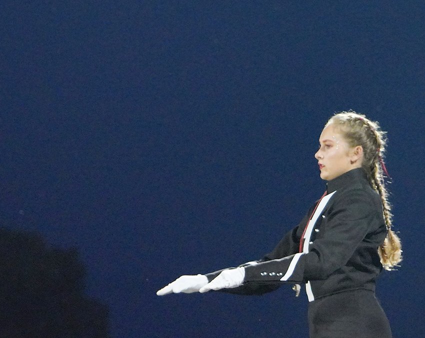 ELC drum major Grace Lutat directs the marching band during a home performance.  Photo by David Swartz