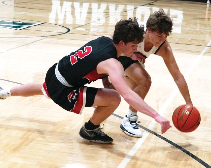 Estherville Lincoln Central&rsquo;s Owen Larson and North Union&rsquo;s Preston Guerdet battle for a loose ball during play in Armstrong on Monday.  Photo by David Swartz