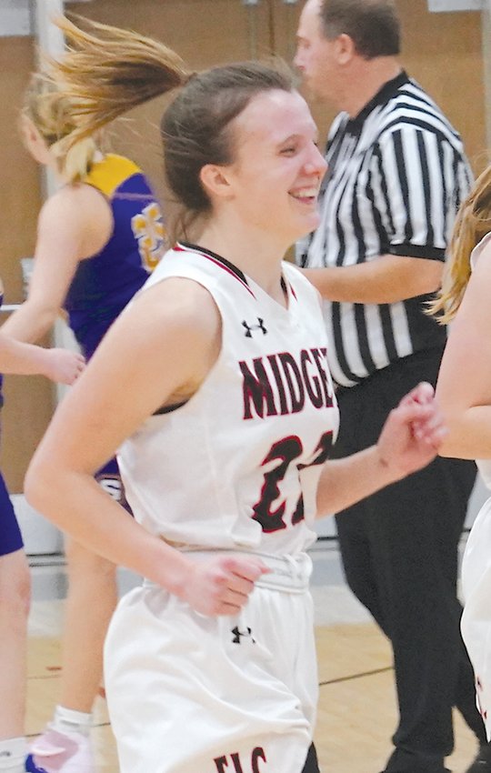 ELC&rsquo;s Jasey Anderson is all smiles after blocking a Spencer shot at the end of the third quarter in the Jan. 24 game. The defensive specialist stepped up offensively, making 4-of-5 3-pointers in the Midgets&rsquo; win over the Tigers.  Photo by David Swartz