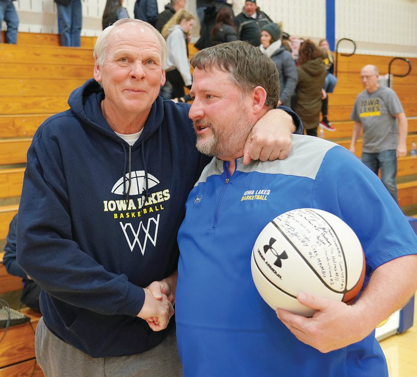 Iowa Lakes Men&rsquo;s Basketball Coach Troy Larson receives congratulations from former coach Bob Grems after Larson surpassed Grems as the college&rsquo;s winningest coach.  Photo by David Swartz