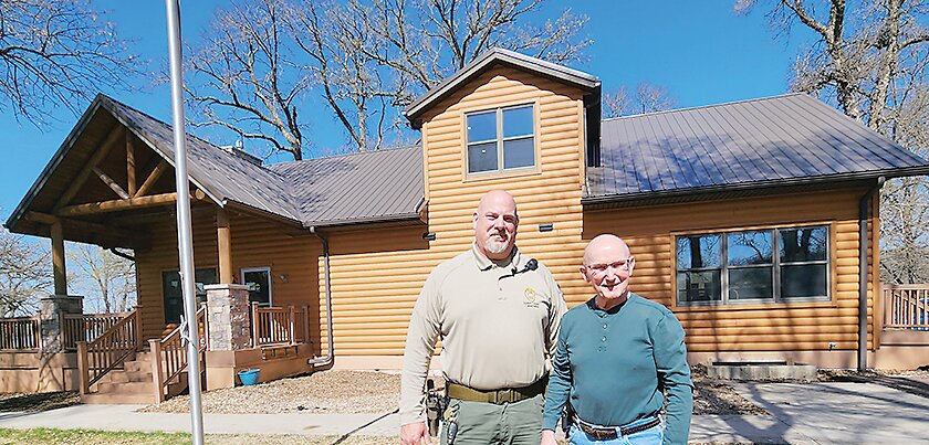 Emmet County Conservation Board Director Eric Anderson and Board Member Curt Larson outside the newly reroofed Nature Center.
