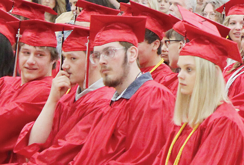 Seniors Ashton Bradley, Dylan Bradley, Noah Breeman, and Mary Carlin listen to the speakers during Sunday&rsquo;s graduation for the Class of 2023.