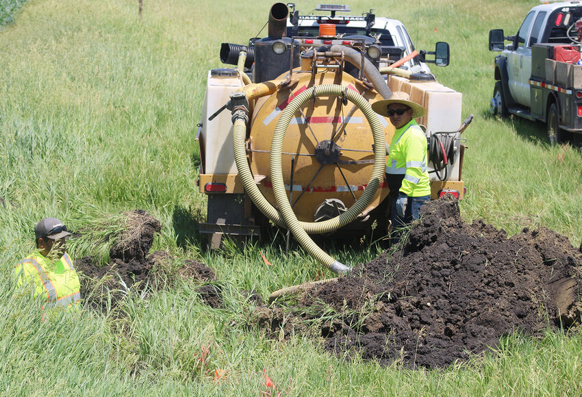 At right: This week, Estherville Communications contractors continued bringing new fiber optics broadband infrastructure to rural areas north of Estherville. Here, workers roll out cable to install on properties along Highway 4.