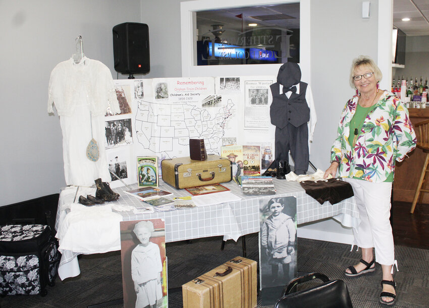 Lori Vicker shows some of her informative display items on the orphan train movement.