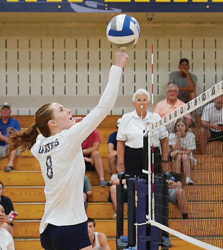 Iowa Lakes&rsquo; Morgan Wigg punches the ball over the net during a recent home match in Estherville.