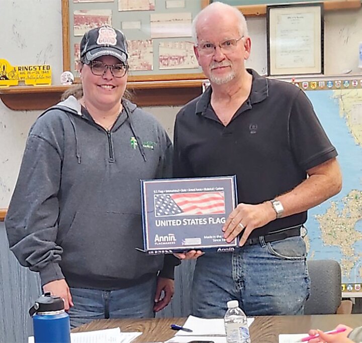 United Lutheran Vicar Kim Kacmarynski presented an American flag to Ringsted Mayor Dan Jorgensen at the Ringsted City Council Monday meeting. The flag flew over the Iowa Capitol Sept. 8.