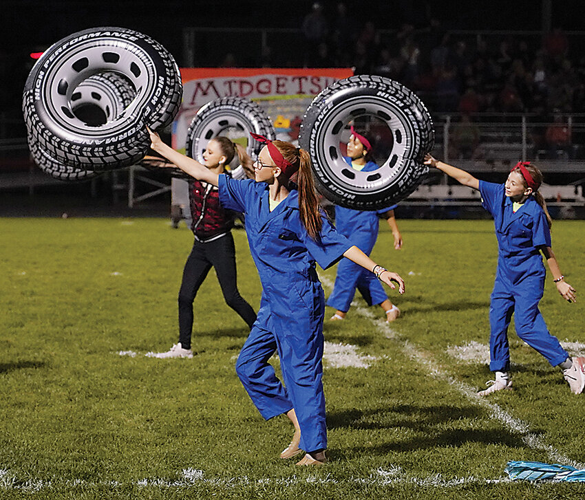 Color guard members Tatum Bates and Ryleigh Fay (front), and  Alyssa Hansen and Jasmine Hurst take part in a half-time performance at a home football game earlier this year.