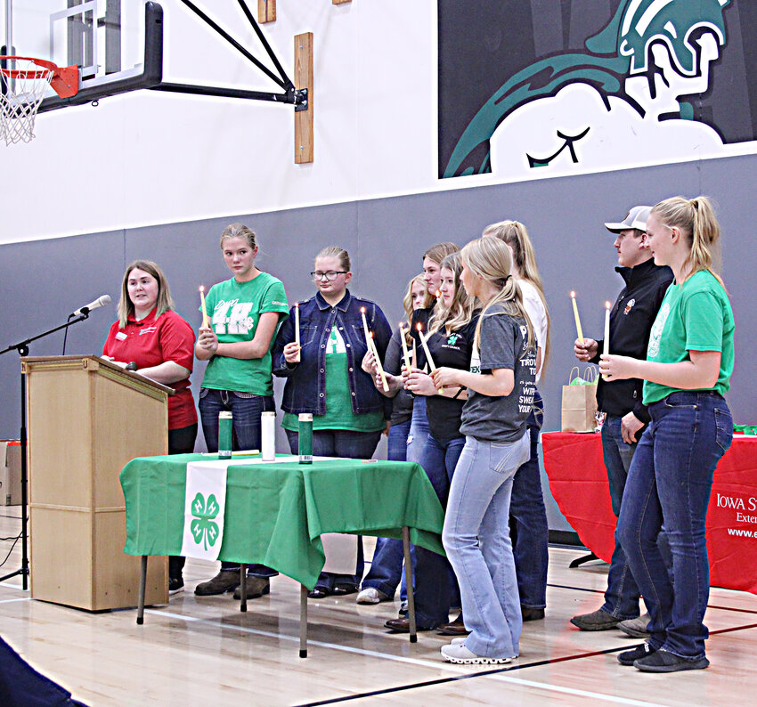 Emmet County Council Members light candles during their induction. Emmet County Extension Youth Coordinator Kaitlyn Herzberg introduces members Helen Lavender, Austin Lavender, Hallie Gray, Cassandra Harvey, Emma Preston, Hanna Paulson, Taylor Larsen, River Rasmussen, and Emily Paulson.