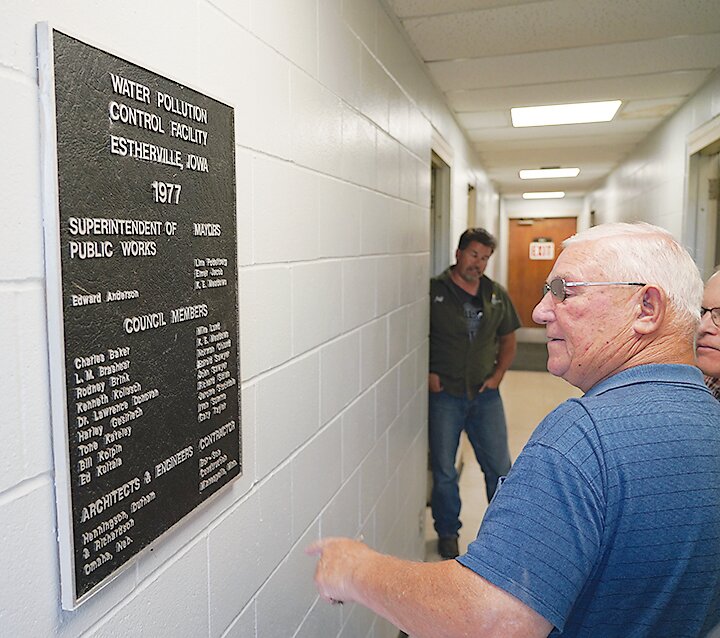 Estherville Mayor Kenny Billings looks at the plaque marking when the city&rsquo;s water pollution control facility was constructed in 1977 during a 2022 tour of the wastewater treatment plant.