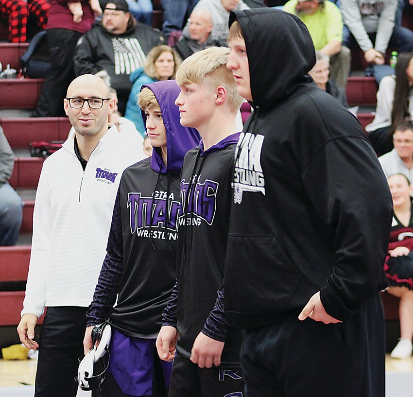 Graettinger-Terril/Ruthven-Ayrshire coach Alex Helmich is in his ninth season at the helm of the Titans. He earned his 100th career dual victory this past weekend. Pictured with Helmich are team captains Caleb Swedin, Isaiah Malm and Donovan Young.