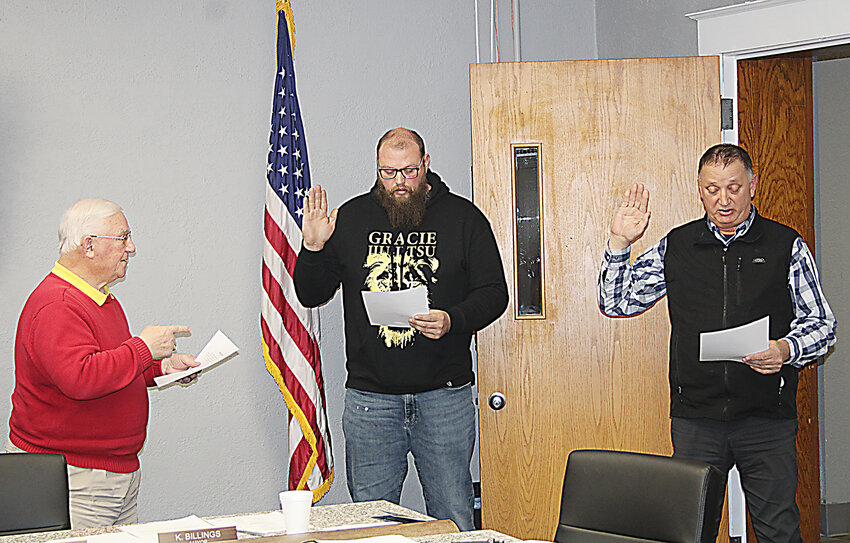 Outgoing mayor Kenny Billings, left, administered the oath of office to mayor-elect A.J. Edwards, center, and at-large council member elect Gary Myers, right. Edwards and Myers begin serving as of Jan. 1, 2024.
