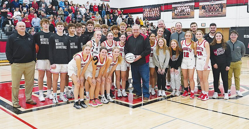 Members and coaches of the Estherville Lincoln Central girls&rsquo; and boys&rsquo; basketball teams honored KILR sports director Dave Van Roekel with a autographed basketball between last Thursday&rsquo;s games with Central Lyon.