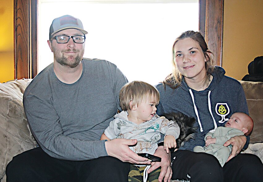 Jesse Michelson, Amanda Paulson, and their sons Jaxson and Liam, pause for maybe their first photo as a family of four on New Year&rsquo;s Day.