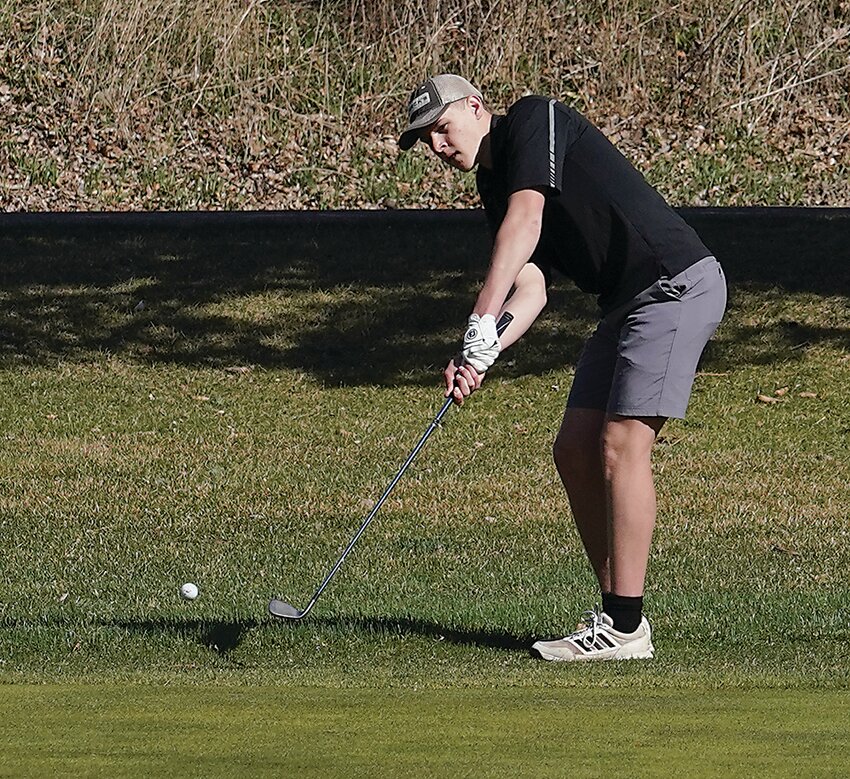 ELC senior Cael Miller chips to the green during a meet last week at the Estherville Golf Course.