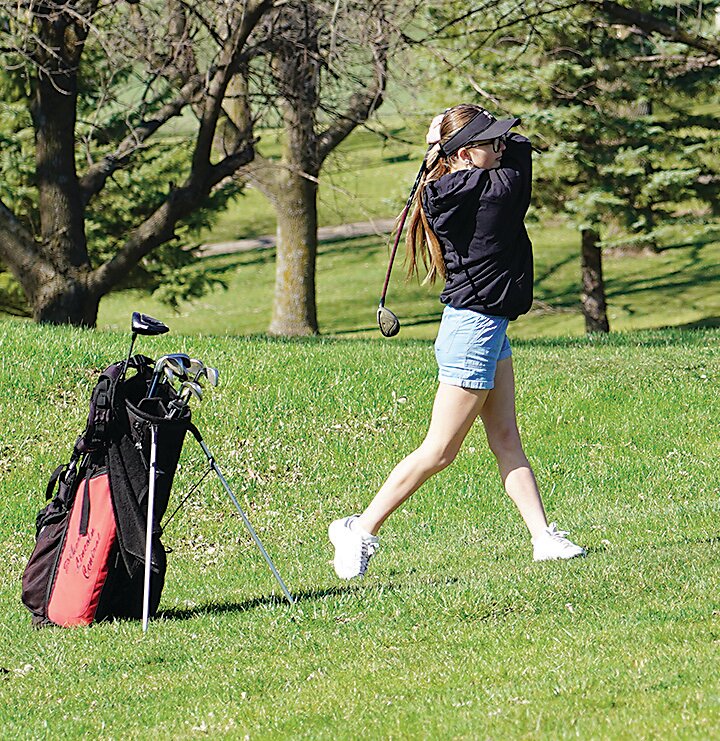 ELC’s Alyssa Hansen hits a drive in the Hole No. 1 fairway at the Estherville Golf Course as the Midgets hosted their invitational on Monday.